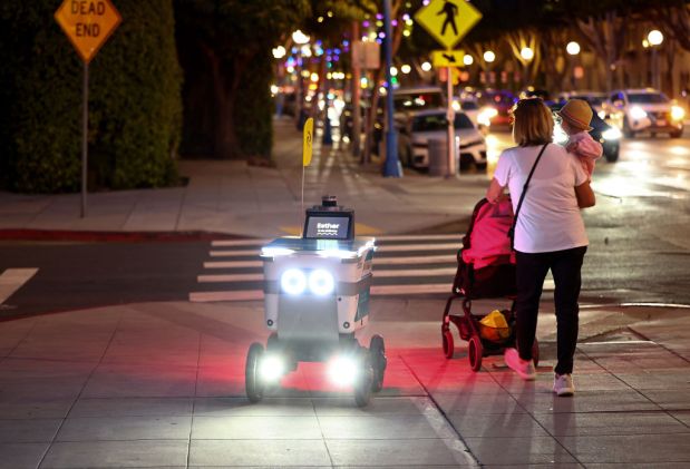Pedestrians Share The Streets With Food Delivery Robots In Parts Of Los Angeles